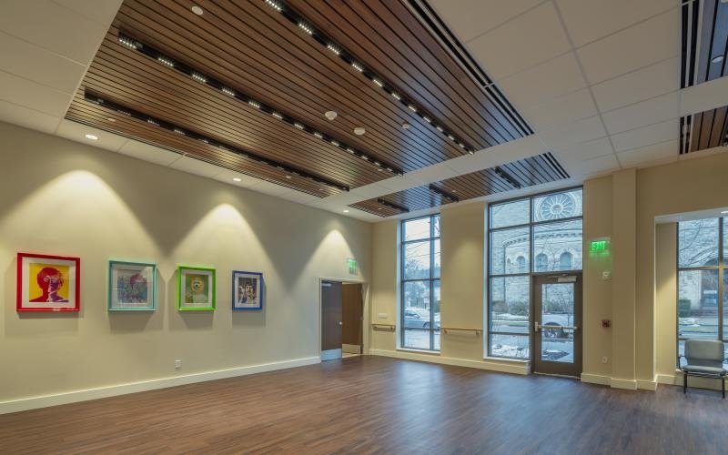 a large room with a wood floor and  art on the wall