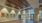 a large room with a wood floor and  art on the wall