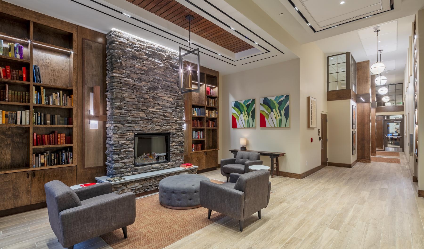 a lobby with a fireplace and seating