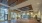 a large room with a wood floor and several windows