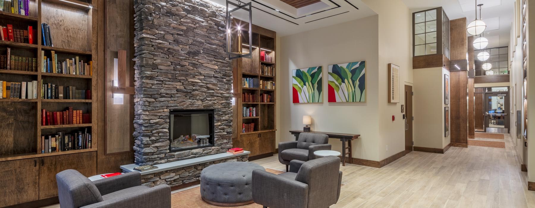 a lobby with a fireplace and seating