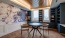 a table and chairs in a room with wallpaper