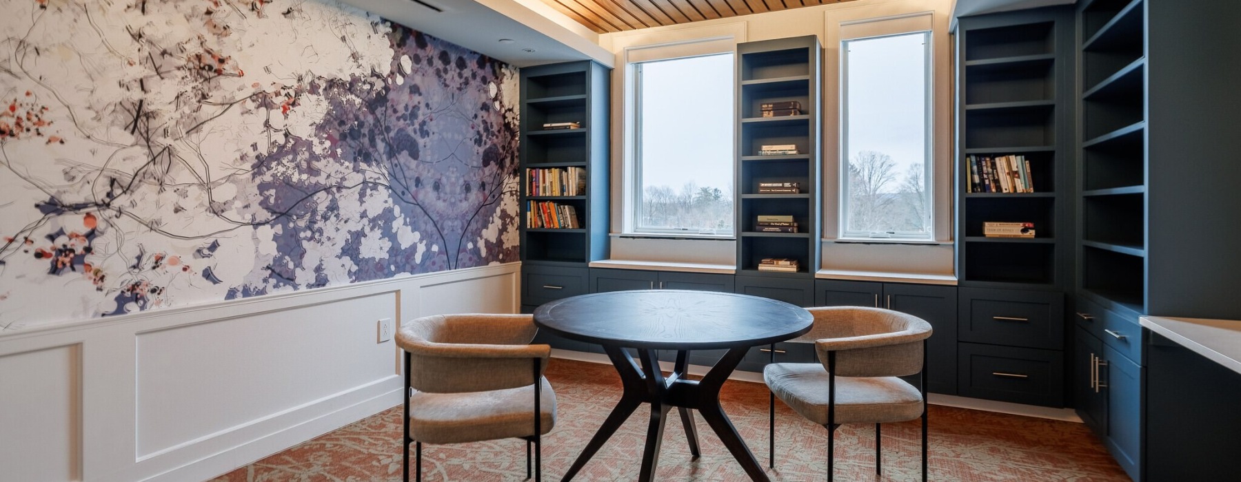 table and chairs in a room with wallpaper